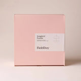 FieldDay Songbird Feeder packaging, plain pink box with white label on grey background.