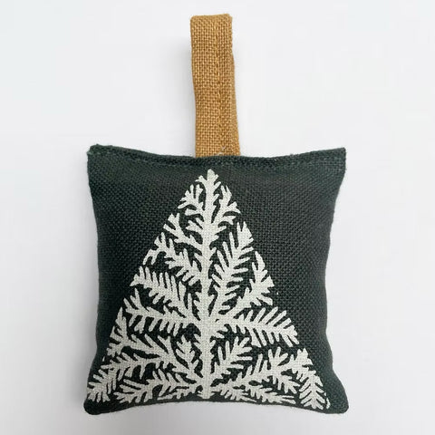 Green coloured Irish Linen scented sachet with white Christmas tree print on grey background.