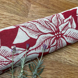 Irish Linen soothing eye pillow with red floral print and lavender scent on a wooden surface