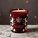 The Handmade Soap Company candle with floral design and brand name on a textured surface. Part of the indulgent hand care gift set.