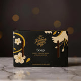 The Handmade Soap Company soap bar. The packaging has a floral design on a dark background. Part of the indulgent hand care gift set.