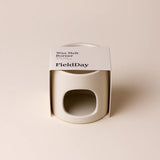 FieldDay White Stoneware wax burner in packaging on a light beige background